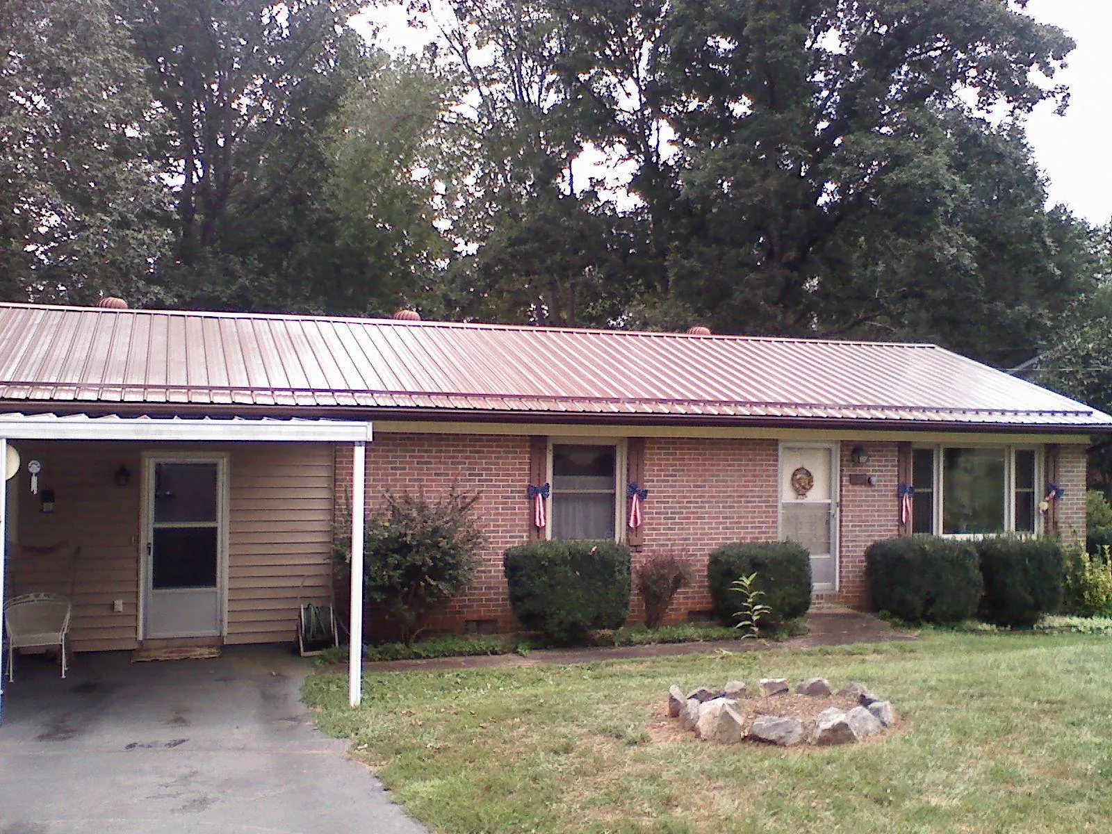 Bronze metal roof and carport on a brick ranch home — Roof Repair work by our crew in Lutherville Timonium