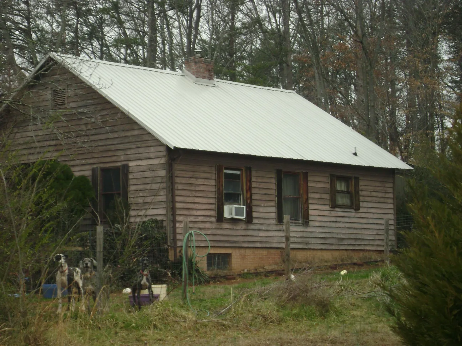 White metal roof on an old wood sided farmhouse, from a Metal Roof Installation job in Lutherville Timonium